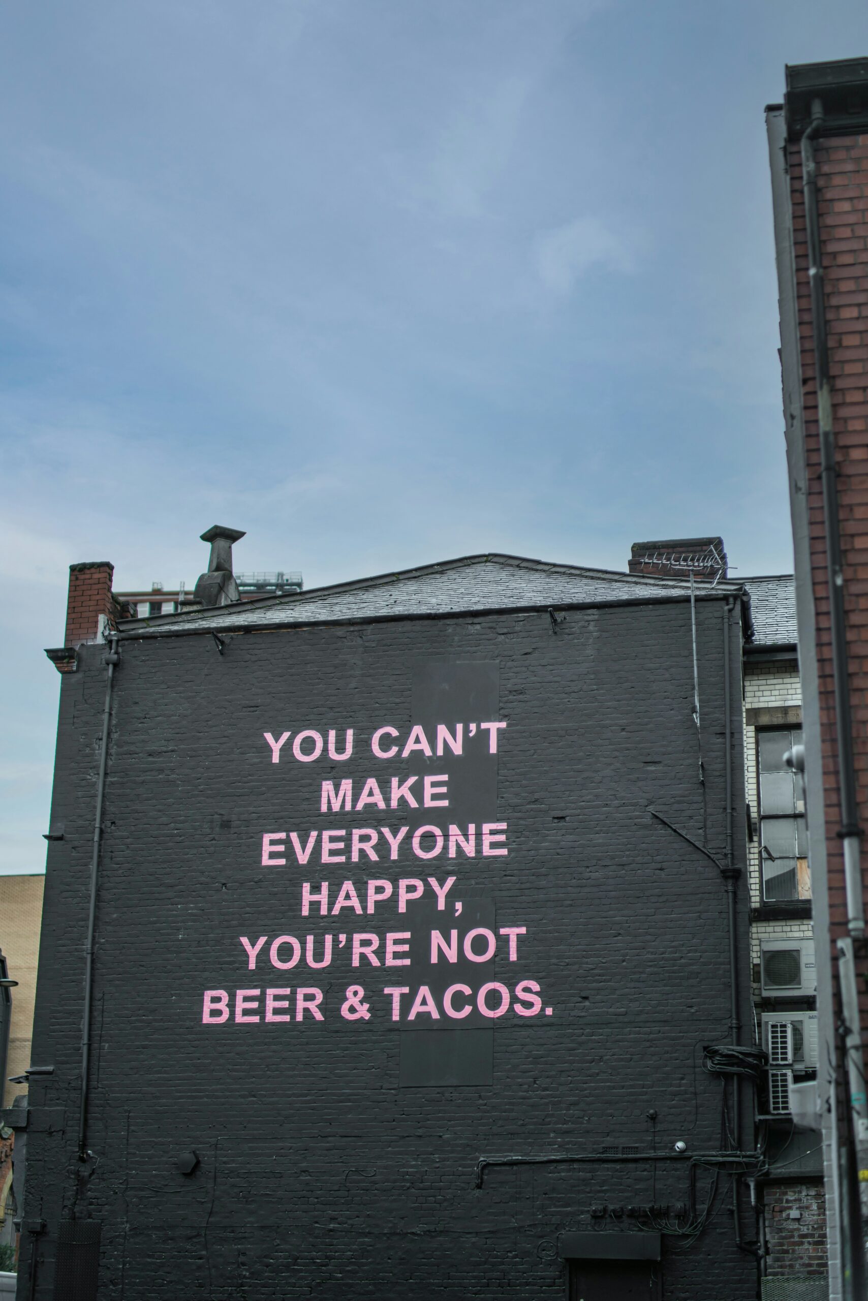 graffitti on a wall used to spread humor about beer and taco pairings