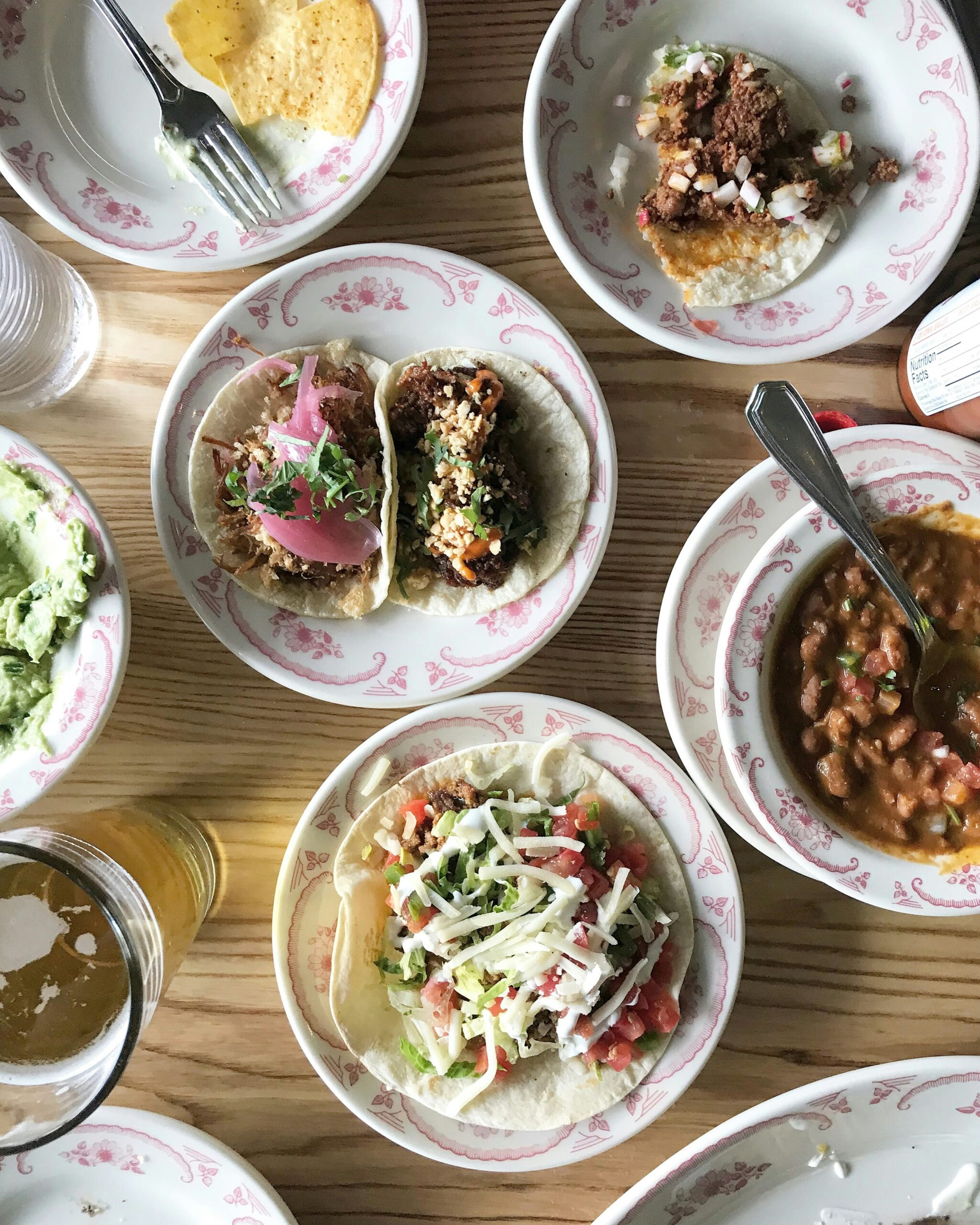 A bright variety of tacos with a beer to show off a variety of Mexican dishes