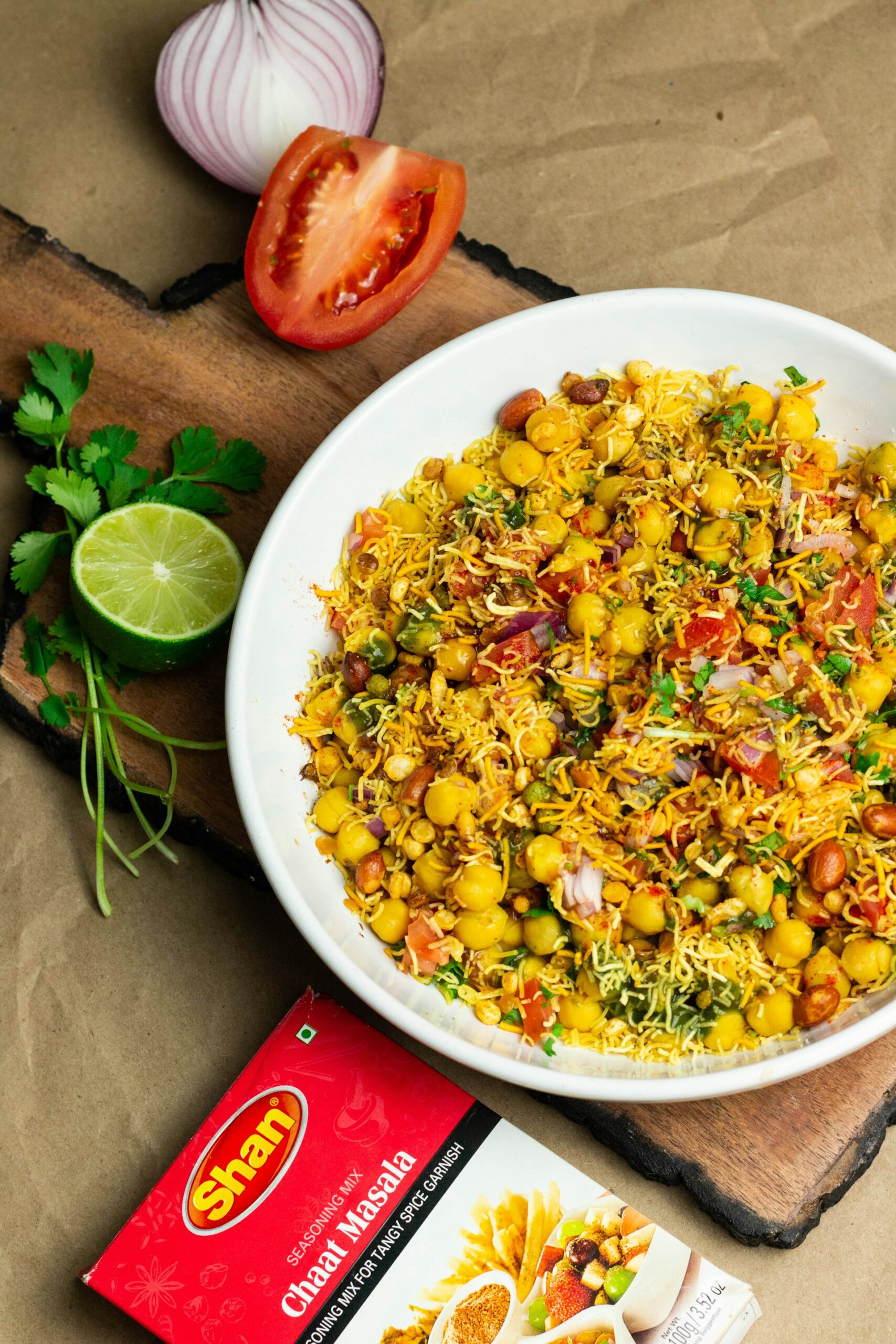 a giant plate of Chaat with some ingredients laying around the plate