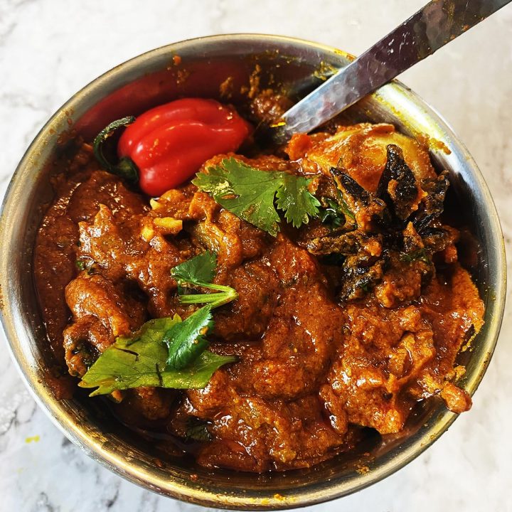 A hearty, rustic curry vindaloo photographed in a simple bowl—for an authentic Indian street‑food feel