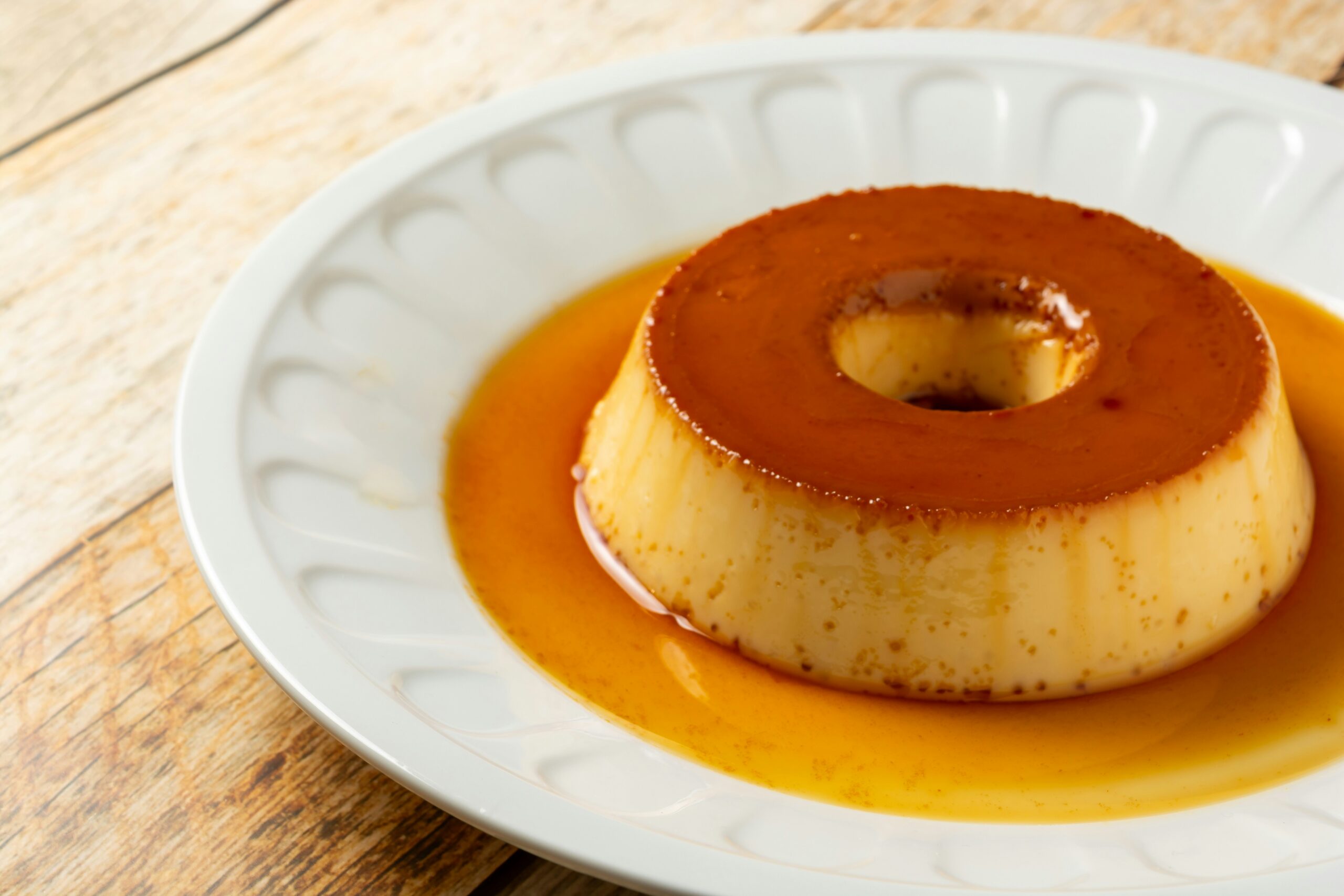 The image shows off a silky serving of Mexican flan dessert