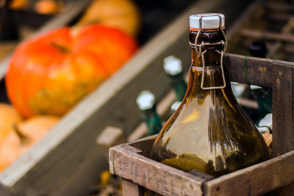 A perfect fall image of bottled beers with pumpkins for halloween